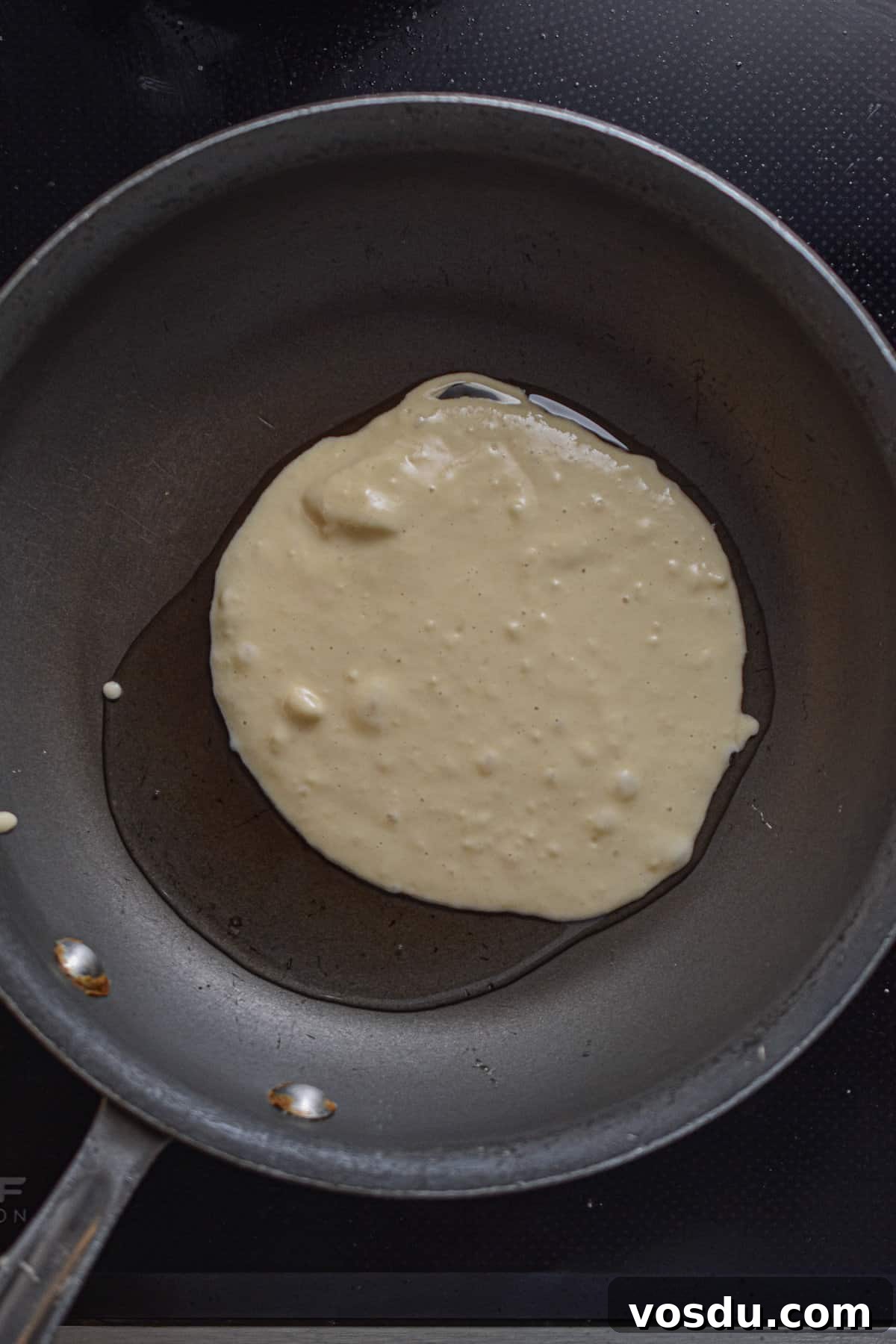 Fluffy Dairy-Free Pancakes Recipe for Breakfast and Brunch 8 The almond milk pancake batter is in a pan with coconut milk.
