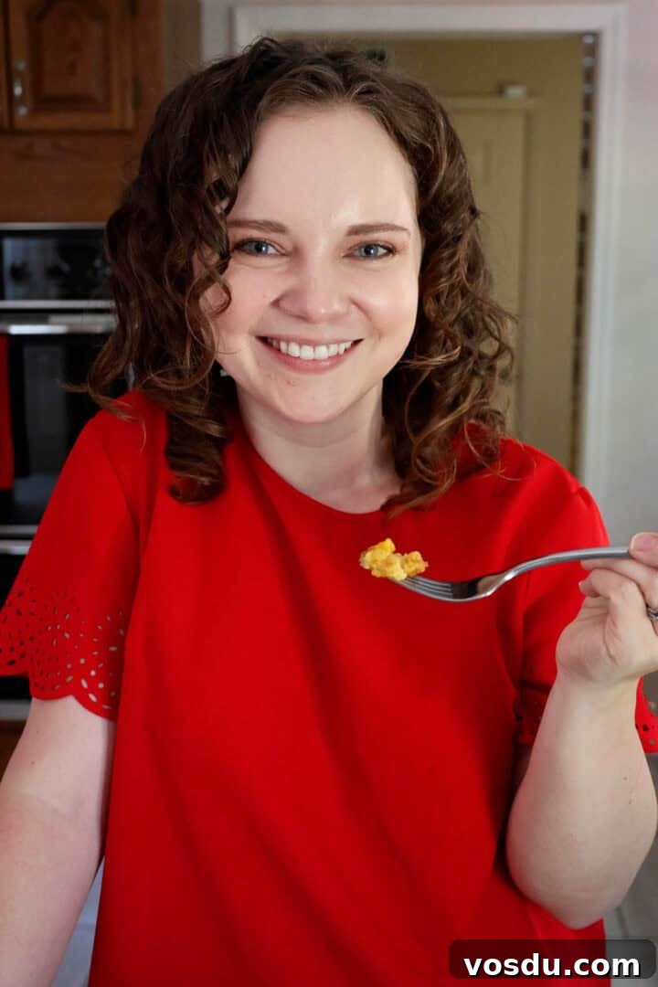 Quick Peach Cobbler Made with Cake Mix and Canned Peaches 11 Kelsey Smith holding a forkful of peach cobbler.