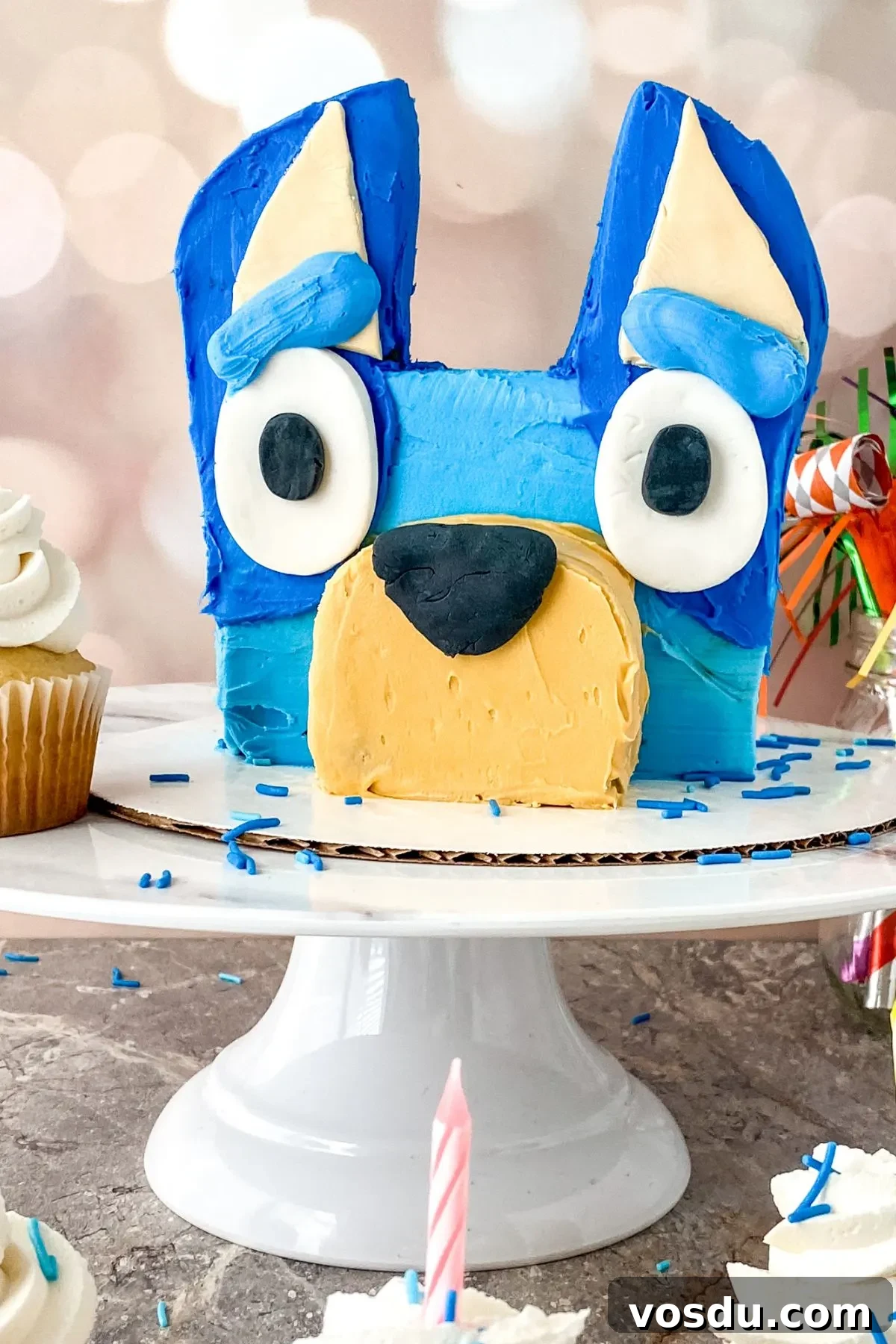 Bluey Cake Recipe with Simple Step-by-Step Tutorial 16 A cake plate and stand with a Bluey Cake.