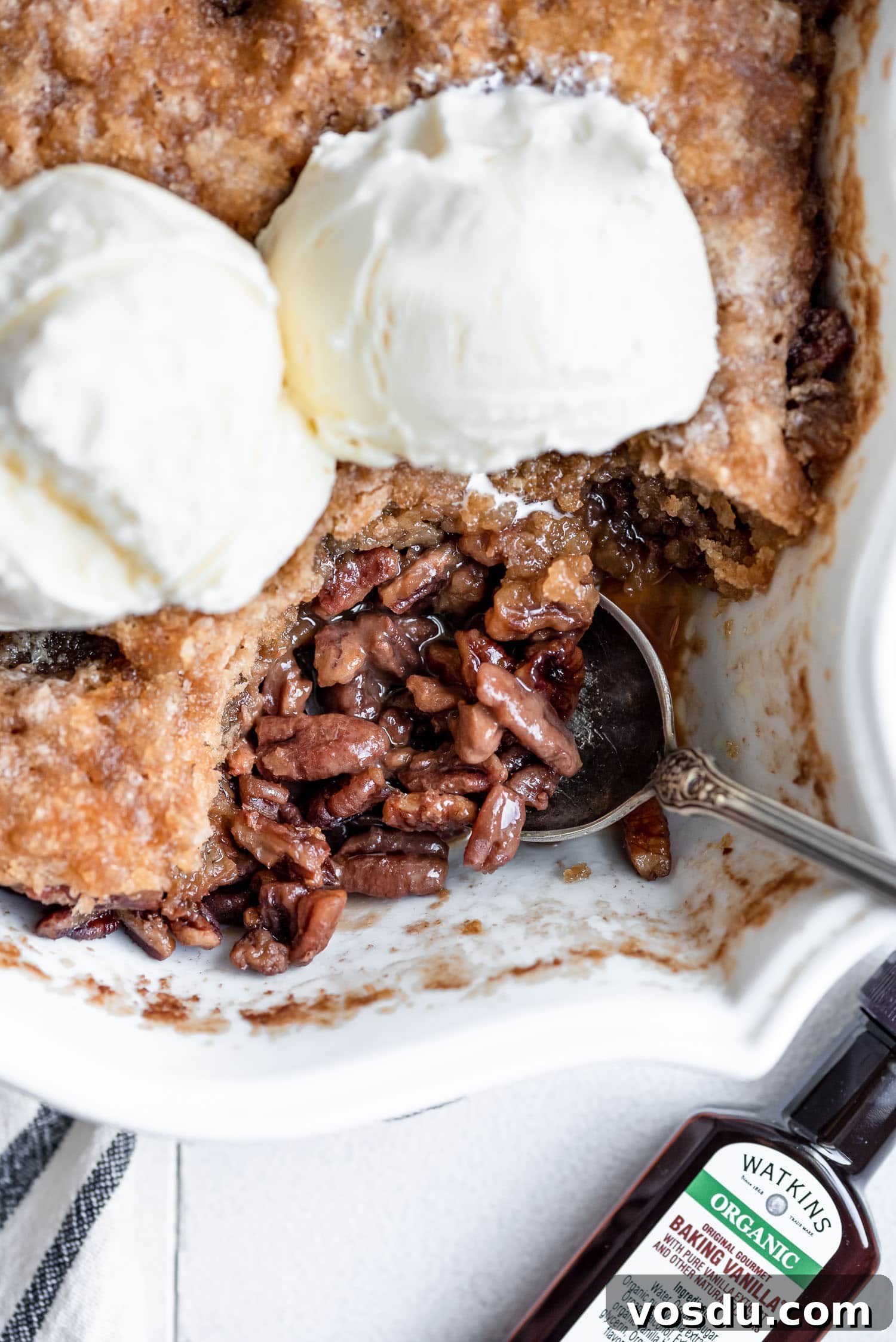 Pecan Pie Cobbler Recipe: Gooey Pecan Filling with Buttery Crust 2 overhead close up pecan pie cobbler topped with ice cream in pan