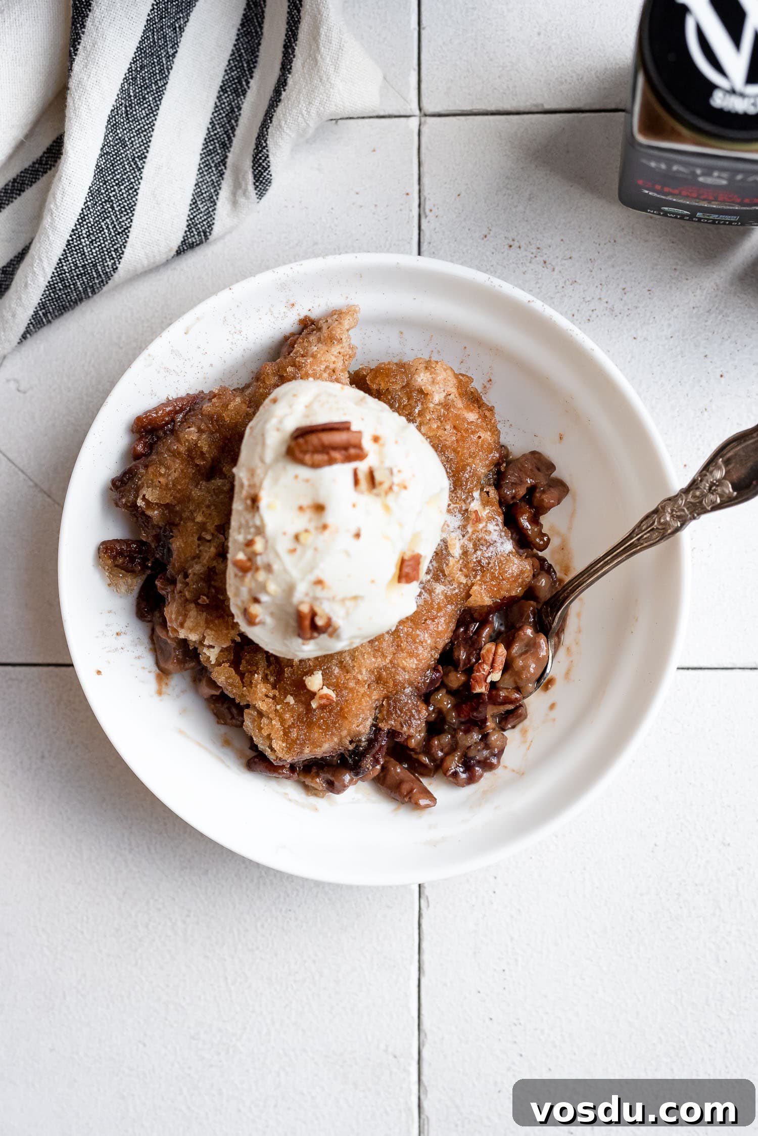 Pecan Pie Cobbler Recipe: Gooey Pecan Filling with Buttery Crust 8 overhead pecan cobbler in bowl with ice cream
