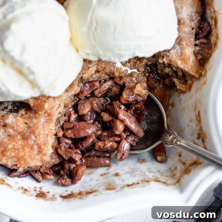 overhead close up pecan pie cobbler topped with ice cream in pan