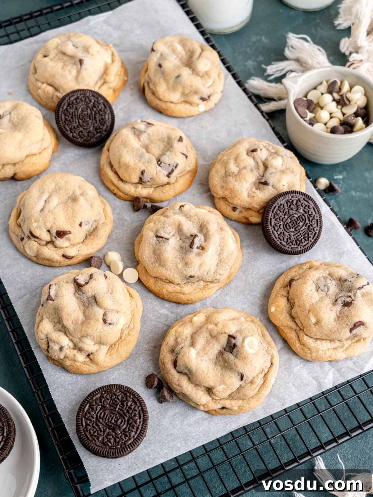Oreo stuffed chocolate chip cookies on a cooling rack with parchment paper.