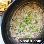 Creamy Rotel Sausage Dip (Slow Cooker Recipe) 12 Sausage rotel dip in slow cooker with chips.