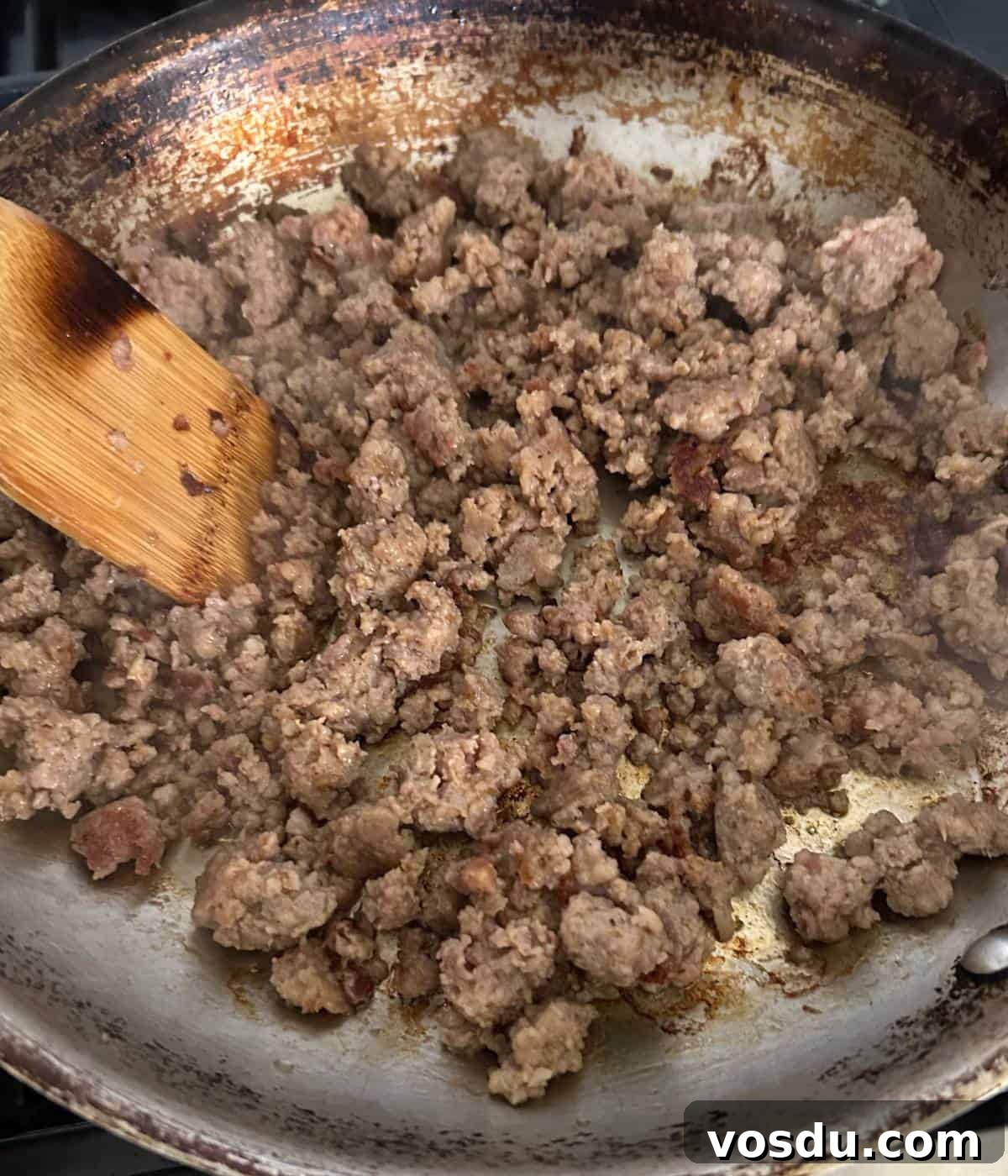 Creamy Rotel Sausage Dip (Slow Cooker Recipe) 4 Browning sausage in pan.