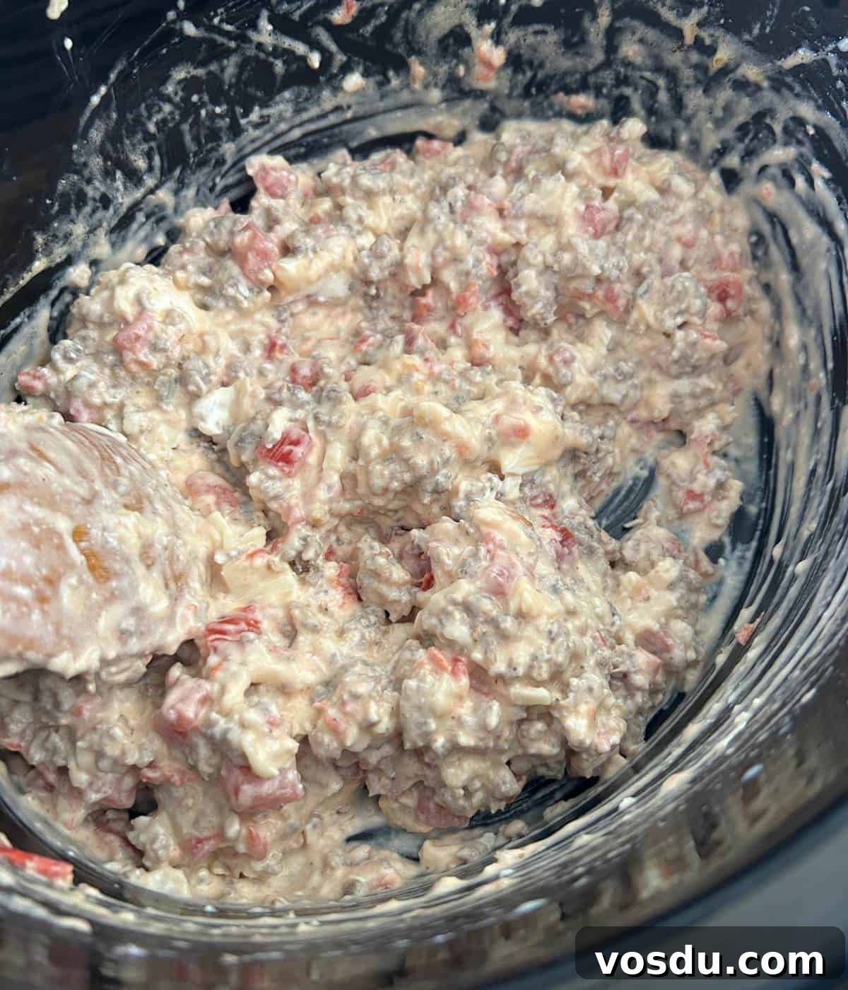 Creamy Rotel Sausage Dip (Slow Cooker Recipe) 6 Stirring dip in crockpot.