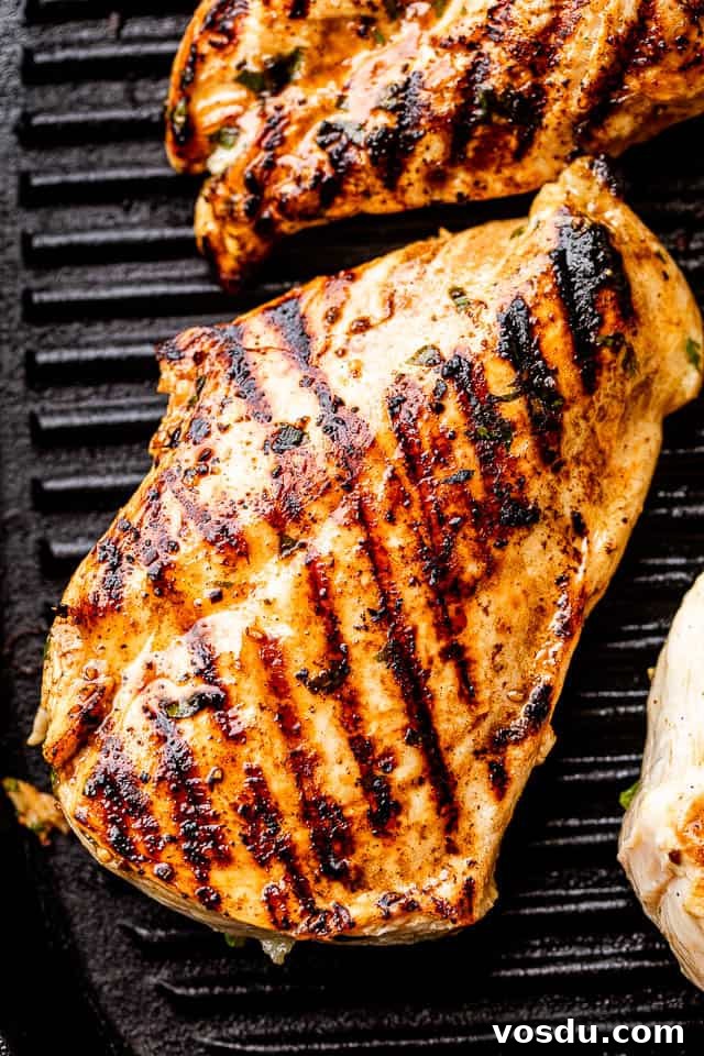 Citrus Mojo Grilled Chicken Recipe — Zesty Caribbean Flavor 4 chicken breast with grill marks set on a black grill pan