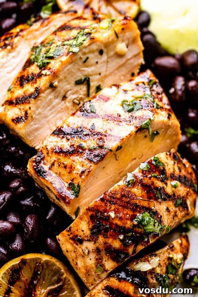 Citrus Mojo Grilled Chicken Recipe — Zesty Caribbean Flavor 6 close up view of mojo chicken with black beans under it