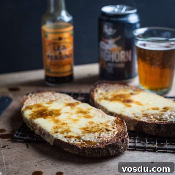 Classic Welsh Rarebit Recipe: Savory Melted Cheese on Toast 3 Cheese on toast, glass of beer and bottle of Worcester sauce