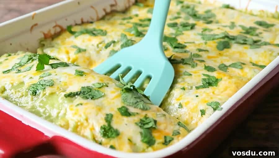 Chicken Enchiladas Verdes (Authentic Green Sauce Enchiladas) 4 Green Enchiladas with Chicken being scooped from the baking pan