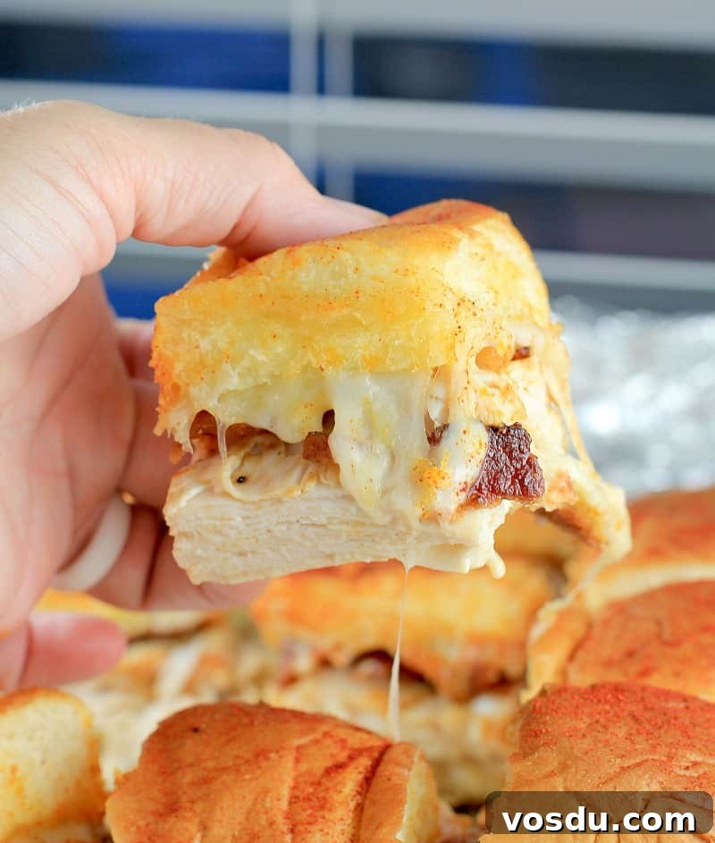 Maple Bacon Turkey Slakers on Hawaiian Rolls 11 side view showing the slider being lifed up to show melty cheese