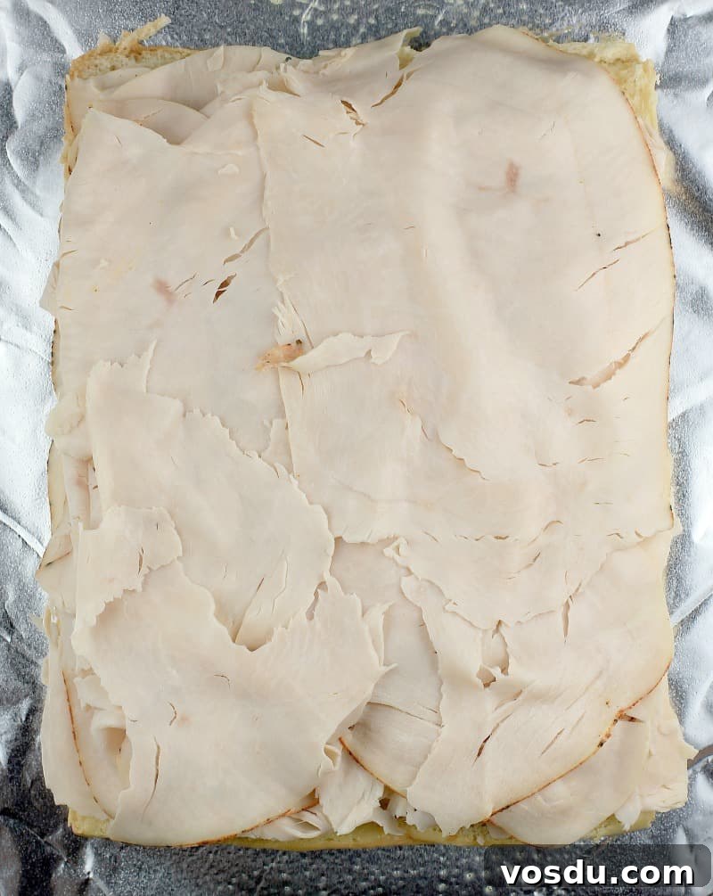 Maple Bacon Turkey Slakers on Hawaiian Rolls 5 top view of the turkey layered on the bread