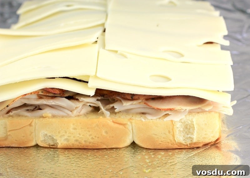 Maple Bacon Turkey Slakers on Hawaiian Rolls 7 side view showing the turkey, bacon, and cheese stacked