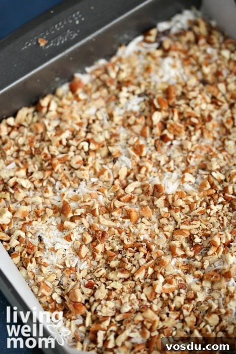 Classic Seven-Layer Bars Recipe with Chocolate and Nuts 8 crushed nuts and shredded coconut mixed together