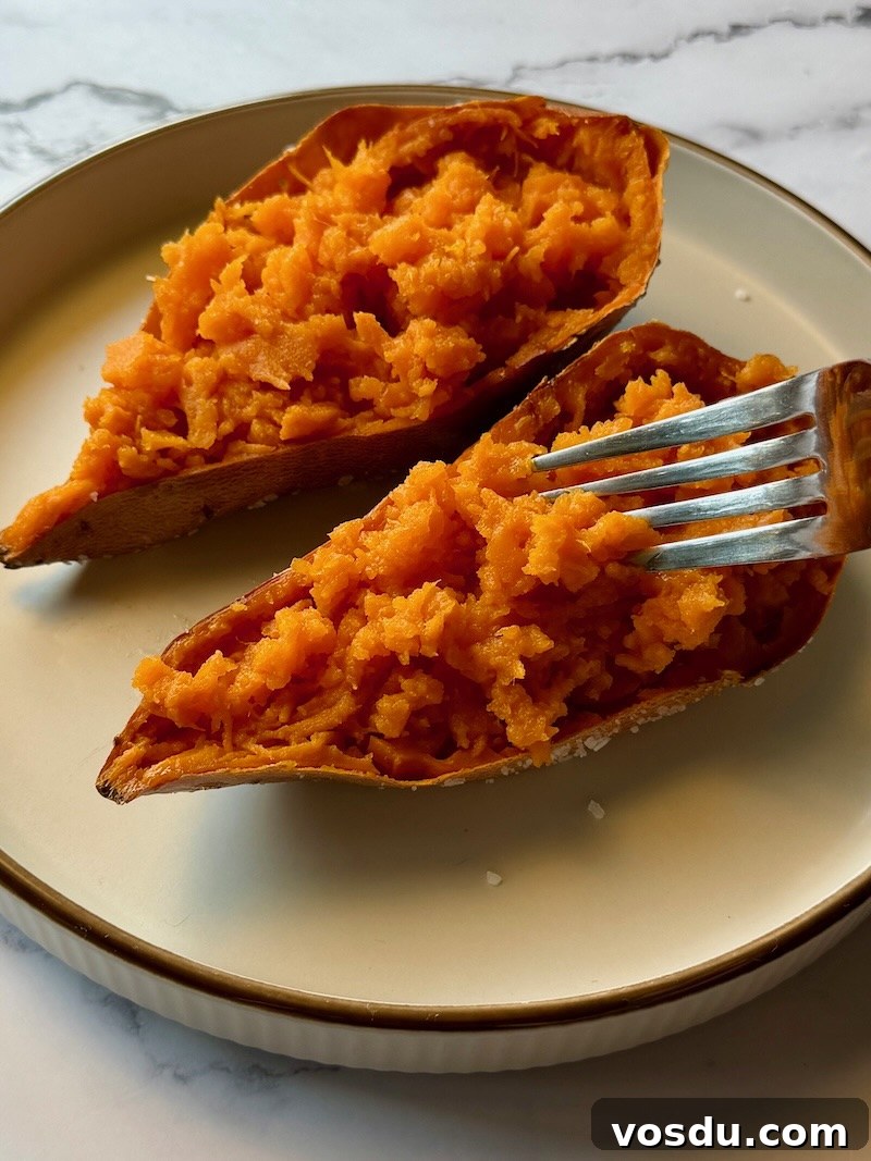 Taco-Stuffed Baked Sweet Potatoes — Savory Comfort Meal 9 Sweet potato fluffed in half and fluffed with fork.