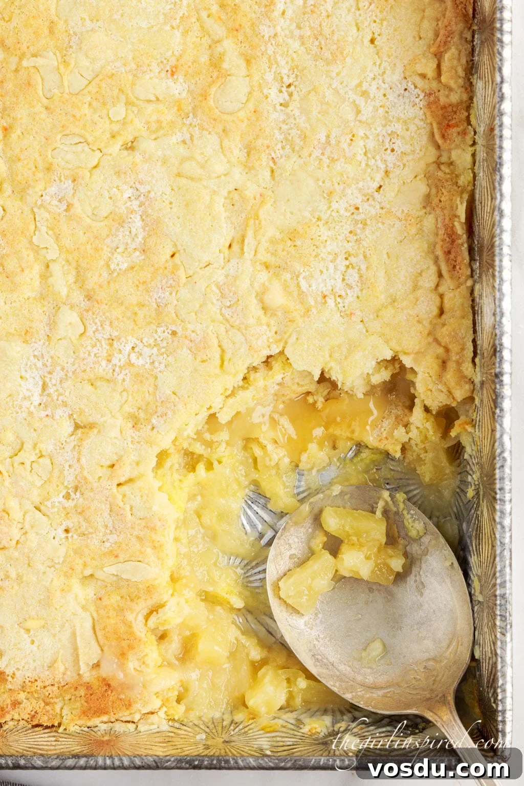 Tangy Lemon Pineapple Dump Cake Recipe for Summer Dessert 3 lemon pineapple dump cake with a scoop taken out