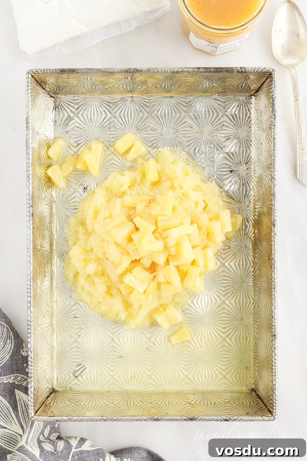 Tangy Lemon Pineapple Dump Cake Recipe for Summer Dessert 5 Pineapple mounded in a metal baking dish.