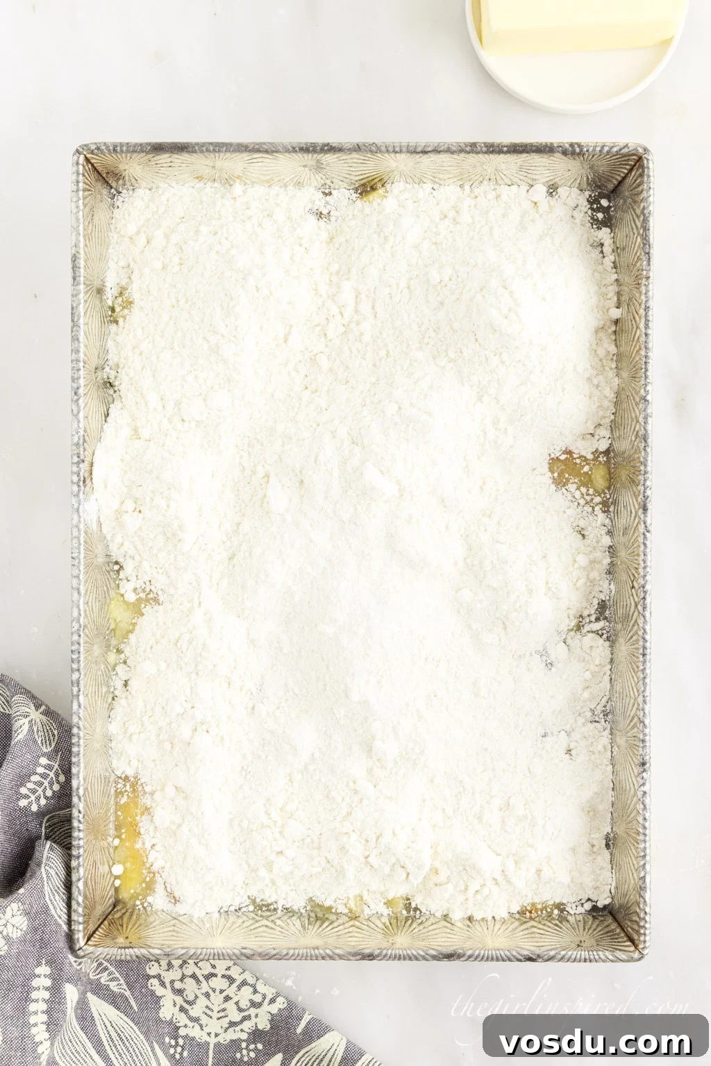 Tangy Lemon Pineapple Dump Cake Recipe for Summer Dessert 7 Cake mix spread over the lemon and pineapple filling in baking dish.