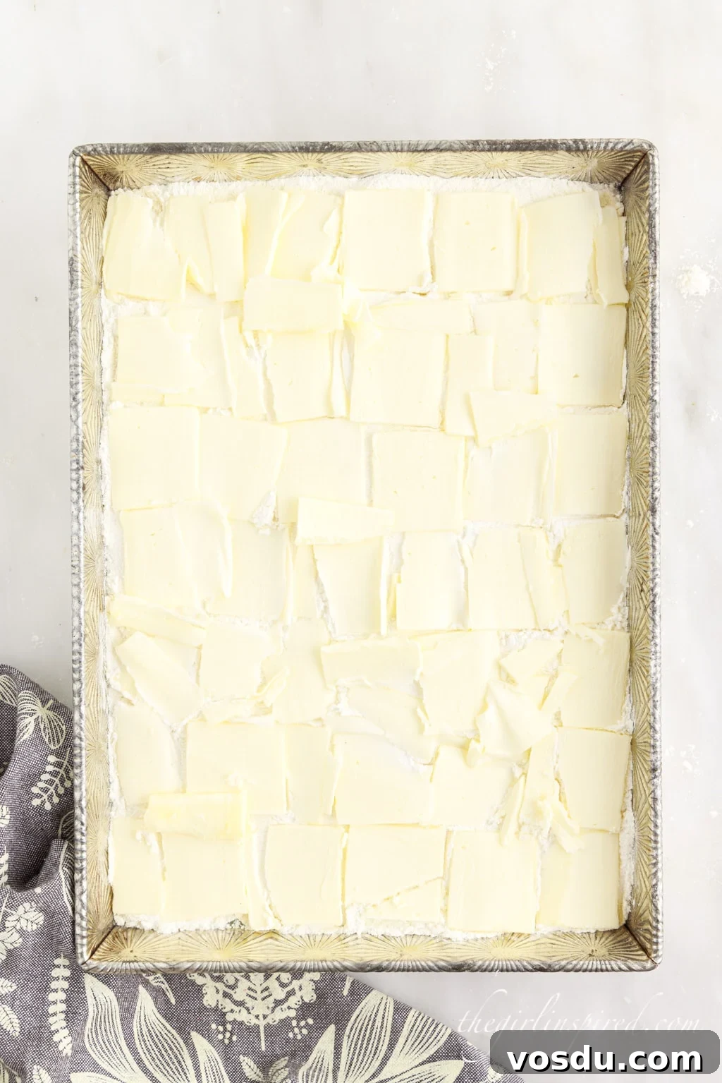 Tangy Lemon Pineapple Dump Cake Recipe for Summer Dessert 8 Pats of butter covering the cake mix across the baking dish.
