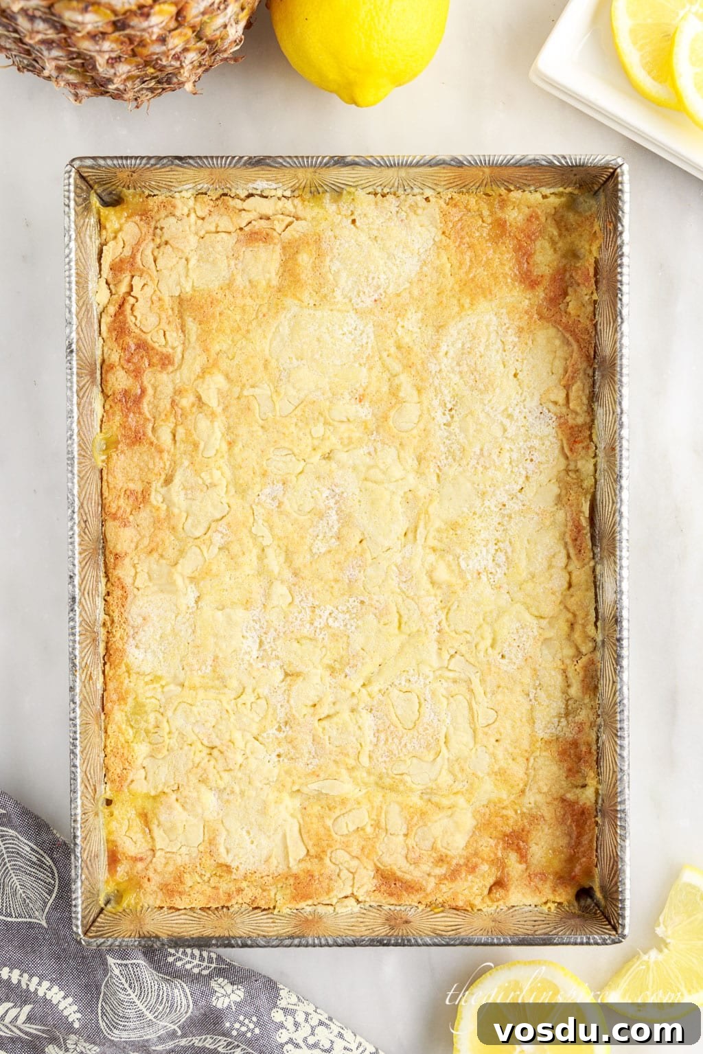 Tangy Lemon Pineapple Dump Cake Recipe for Summer Dessert 9 Top view of the baked lemon pineapple dump cake in a silver baking pan.