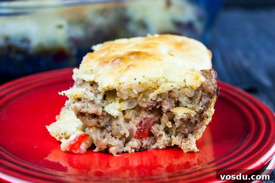 Savory Sausage Breakfast Cake Recipe for Brunch and Meal Prep 6 Sausage Breakfast Cake Recipe - serving of the sausage cake on red plate