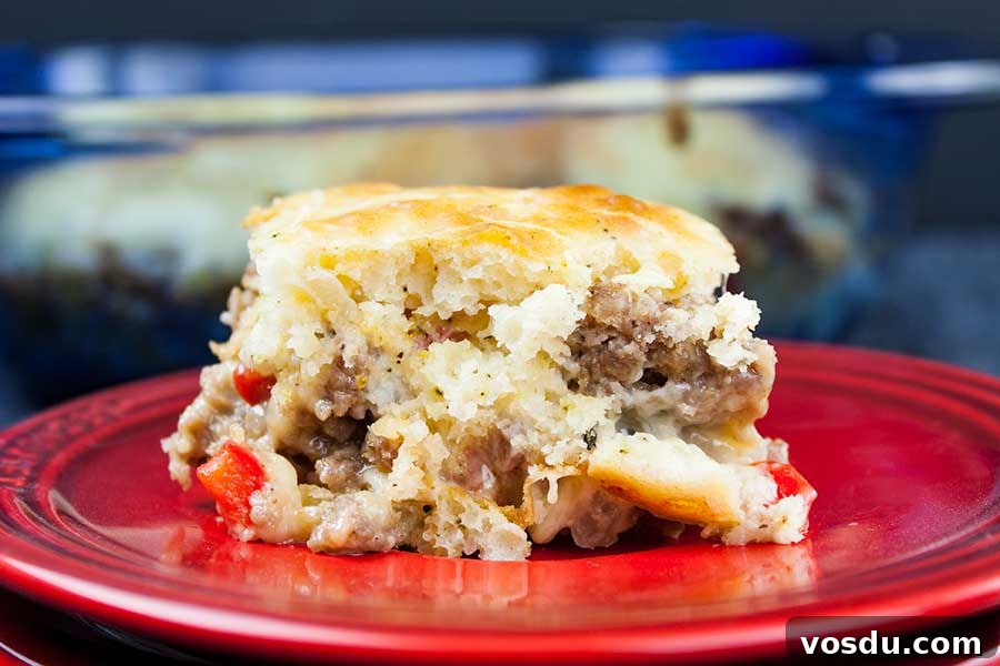 Savory Sausage Breakfast Cake Recipe for Brunch and Meal Prep 7 Sausage Breakfast Cake Recipe - closeup of a serving of the sausage cake on a red plate