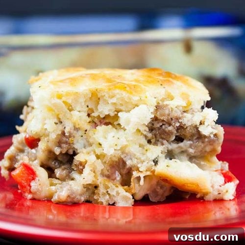 Savory Sausage Breakfast Cake Recipe for Brunch and Meal Prep 8 Sausage breakfast cake on a red plate.