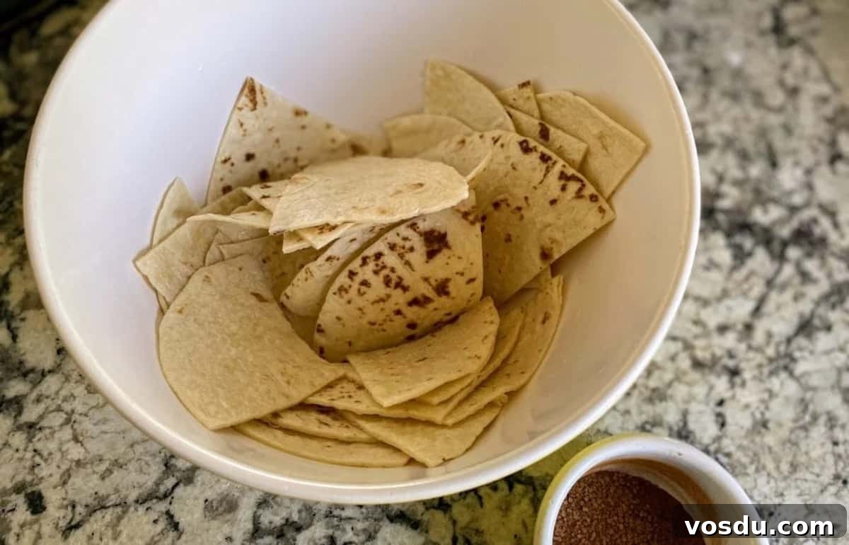Crunchy Vegan Nachos with Spicy Cashew Cheese 4 tortillas in a bowl with lime juice