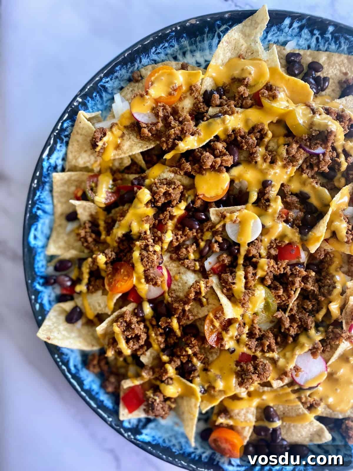 Crunchy Vegan Nachos with Spicy Cashew Cheese 7 Layer 1 of vegan nachos on the table