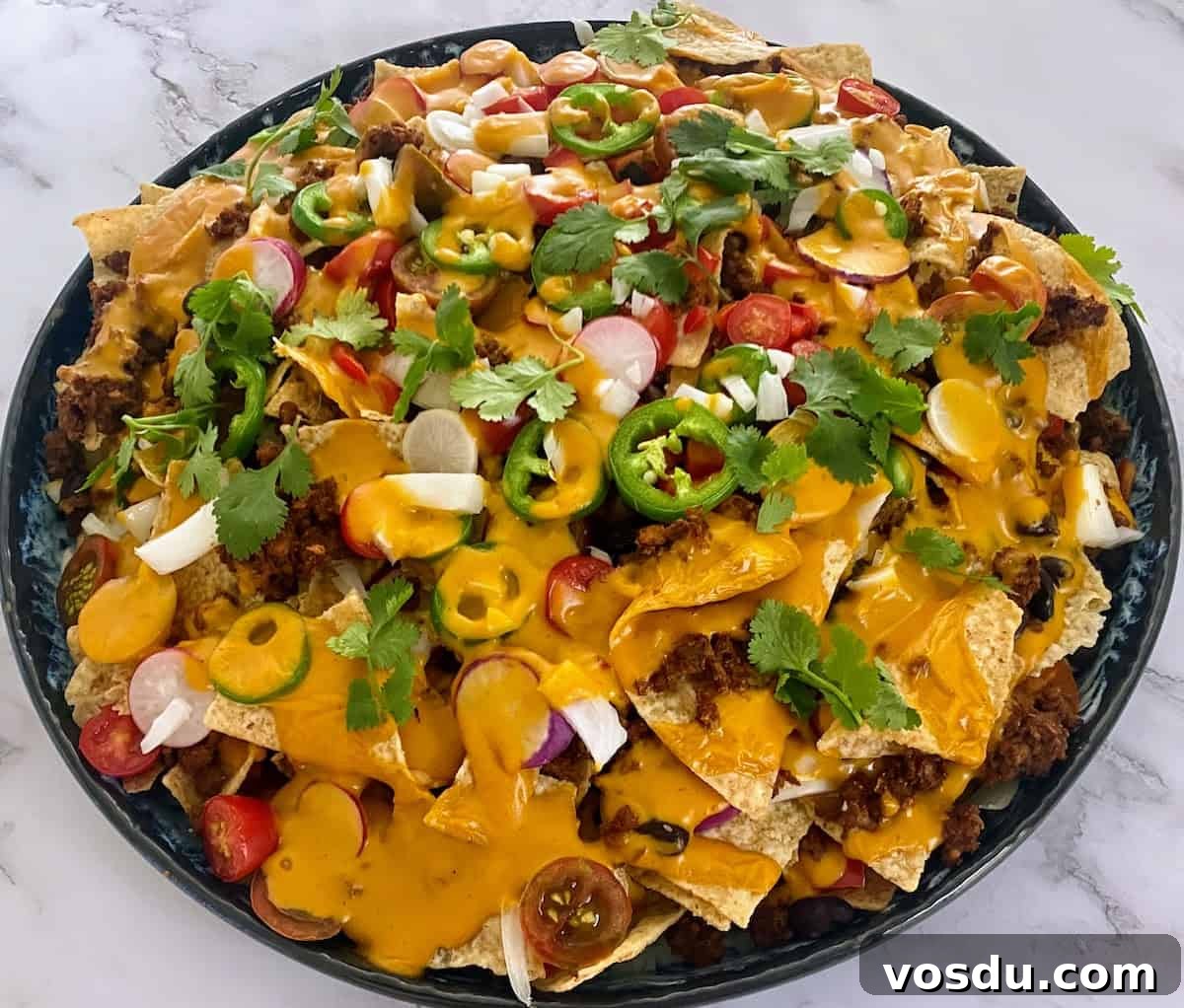 Crunchy Vegan Nachos with Spicy Cashew Cheese 9 Vegan nachos on a platter on the table