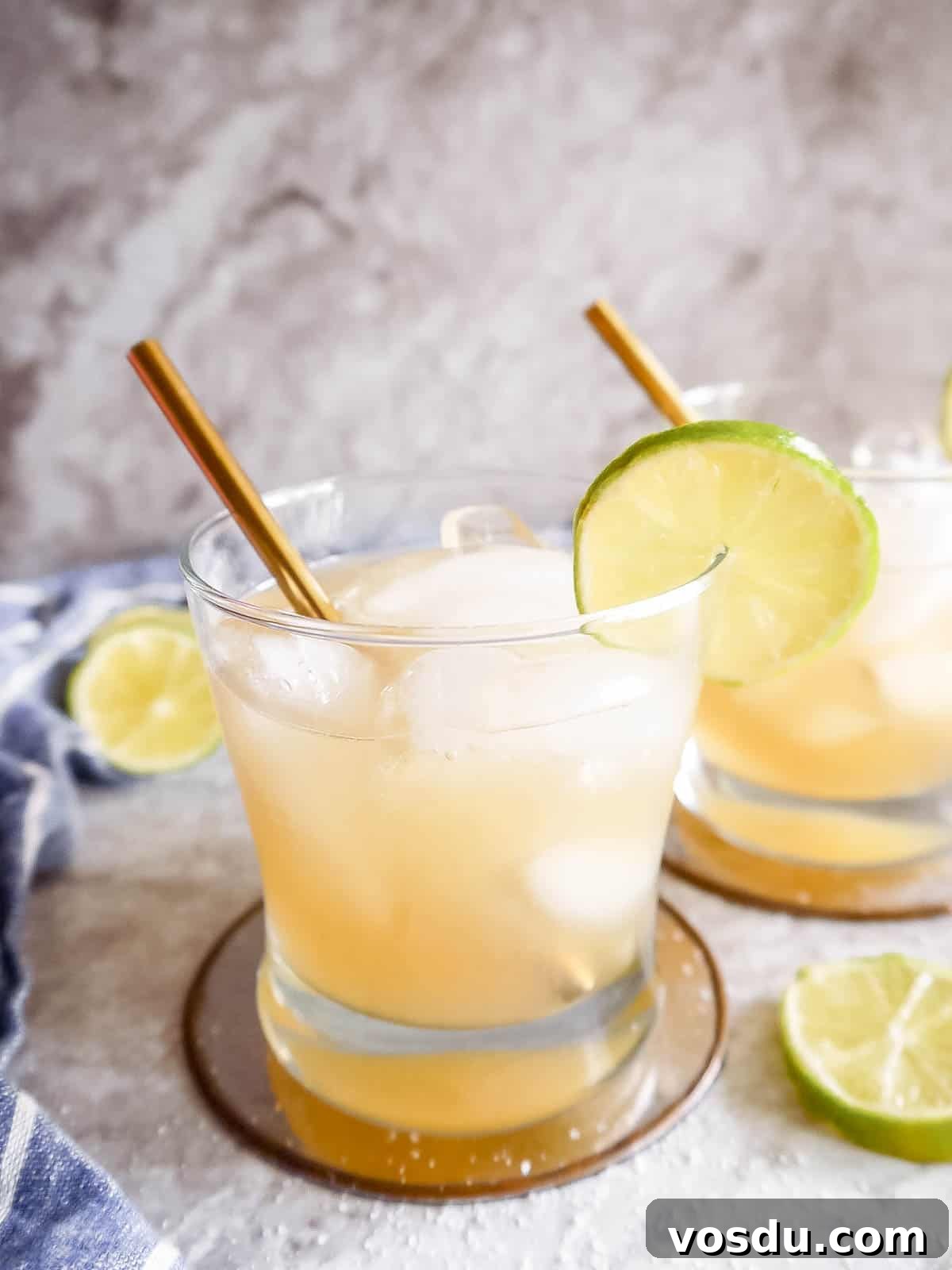 Cointreau Margarita Recipe: Classic Cocktail Guide and Tips 5 Two glasses of Cointreau Margaritas with limes on the rim.