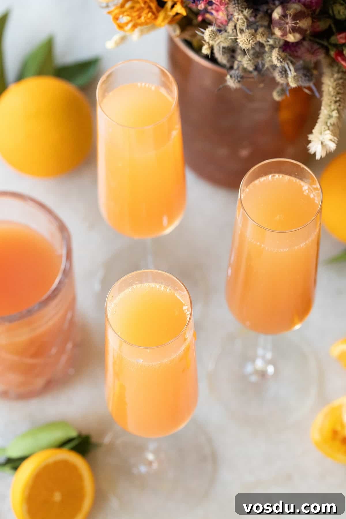 Citrus Grapefruit Mimosa Recipe — Bright Brunch Cocktail 2 Grapefruit mimosa on a counter.