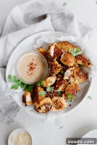 A plate with chicken nuggets and dipping sauce.