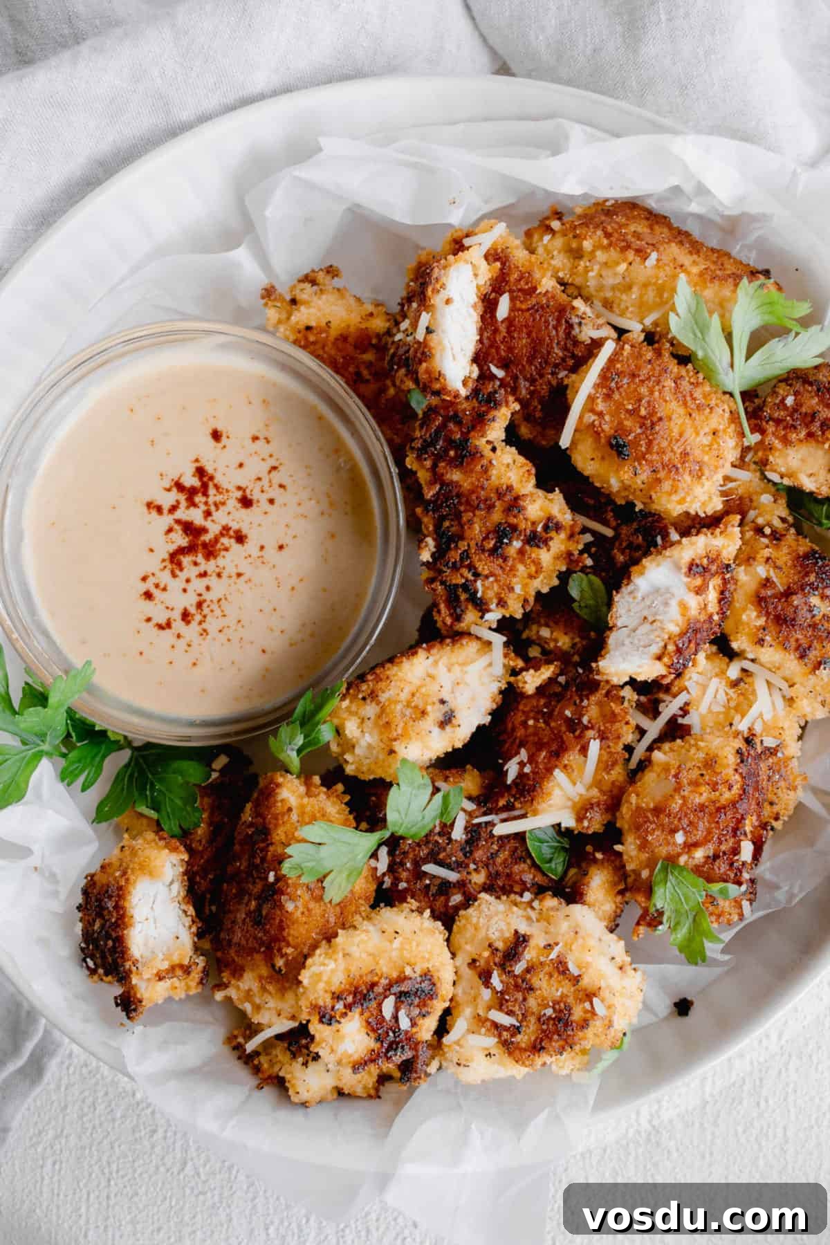 chicken nuggets on plate with dipping sauce.