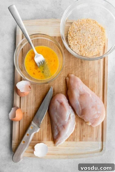 A cutting board with chicken nuggets and seasonings.