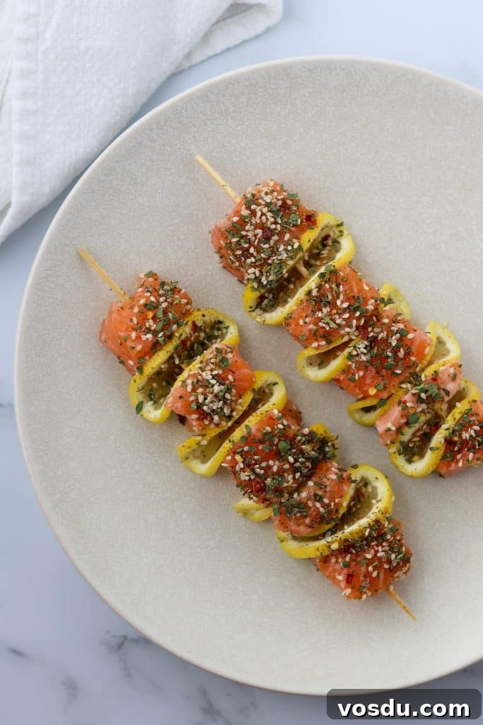 Lemon-Spiced Salmon Skewers with Herb Marinade 4 A plate with salmon skewers with lemon slices