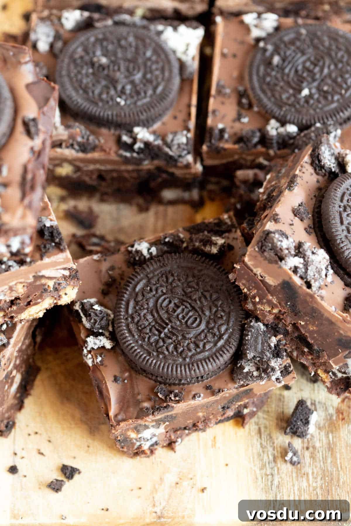 No-Bake Chocolate Oreo Tiffin Recipe — Quick No-Bake Dessert 11 Oreo tiffin bars on a wooden board.