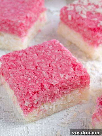 A few squares of coconut ice on a lace tablecloth.