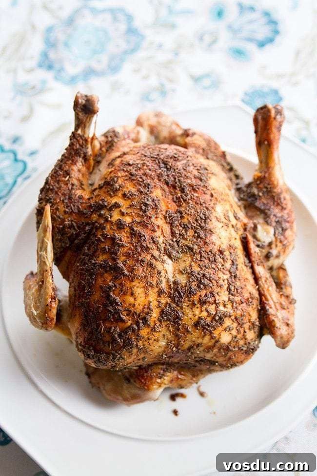 Herb and Garlic Butter Roasted Low-Carb Chicken Recipe 3 Herb & Butter Roasted Low Carb Chicken on a White Platter