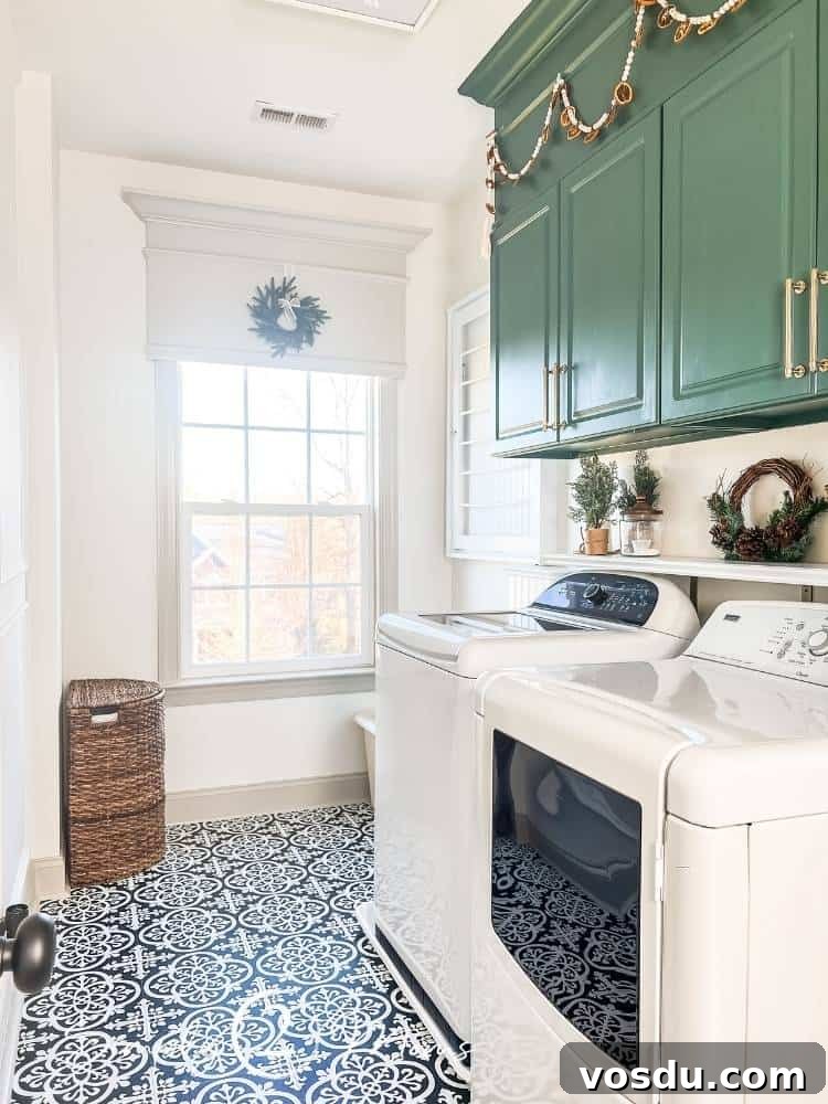 Country Chic Christmas Home Tour That Inspires Holiday Decorating 26 Country chic laundry room with peel and stick tile floors is decorated for Christmas. A wreath hangs on the custom wood valance and garland hangs above the green painted cabinets.