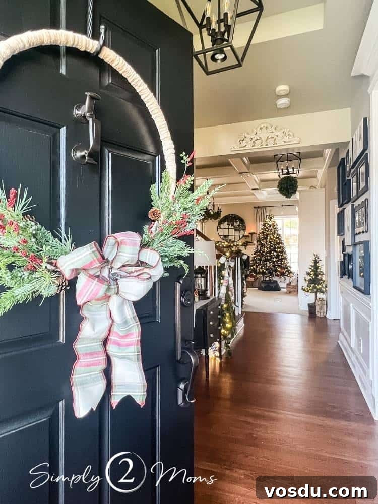 Country Chic Christmas Home Tour That Inspires Holiday Decorating 6 Black front door decorated for Christmas with a DIY yarn hoop wreath opened up to a country chic style home decorated for the holidays.