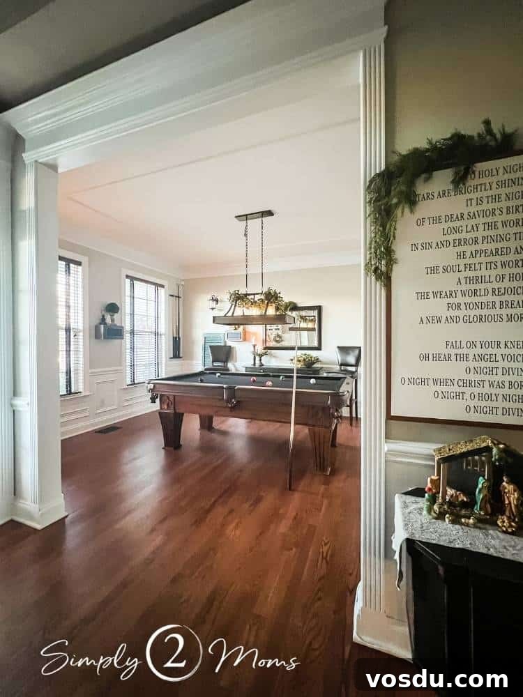 Country Chic Christmas Home Tour That Inspires Holiday Decorating 9 View from hallway into a game room with a pool table decorated for Christmas