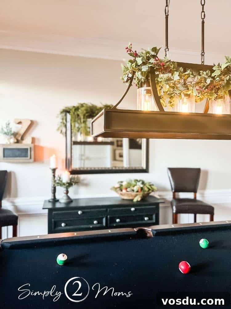 Country Chic Christmas Home Tour That Inspires Holiday Decorating 10 Game room with pool table decorated for Christmas with greenery on the pool table light.