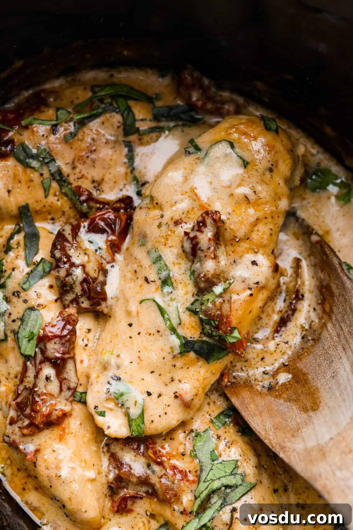 Closeup of Crock Pot Marry Me Chicken in a creamy sun-dried tomato and parmesan sauce. Closeup of Crock Pot Marry Me Chicken.
