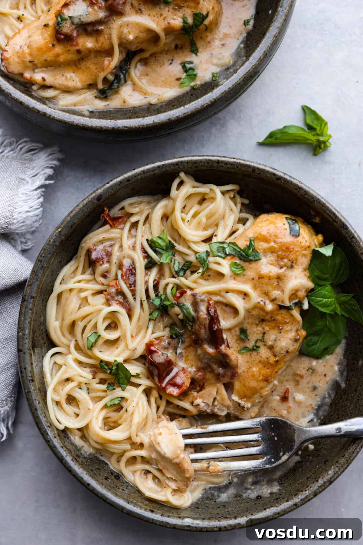 Crock Pot Marry Me Chicken served over pasta with fresh basil. Crock Pot Marry Me Chicken served over spaghetti noodles.