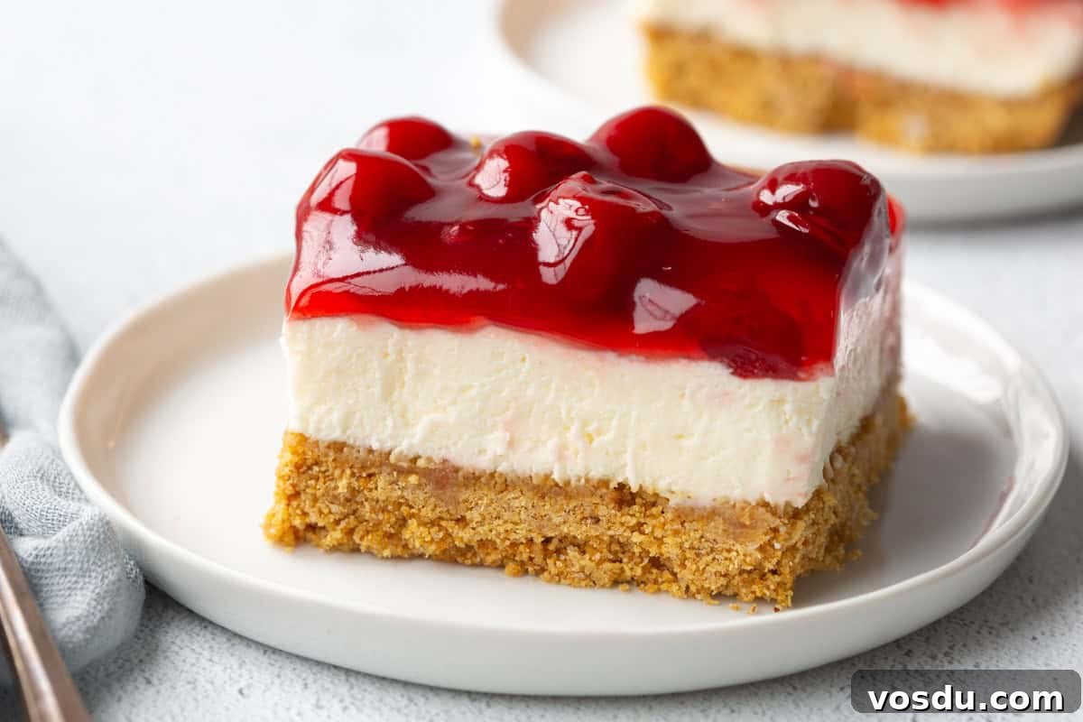 Cherry Delight: Homemade Cherry Dessert Recipes for Summer 12 slice of cherry delight on a white plate.