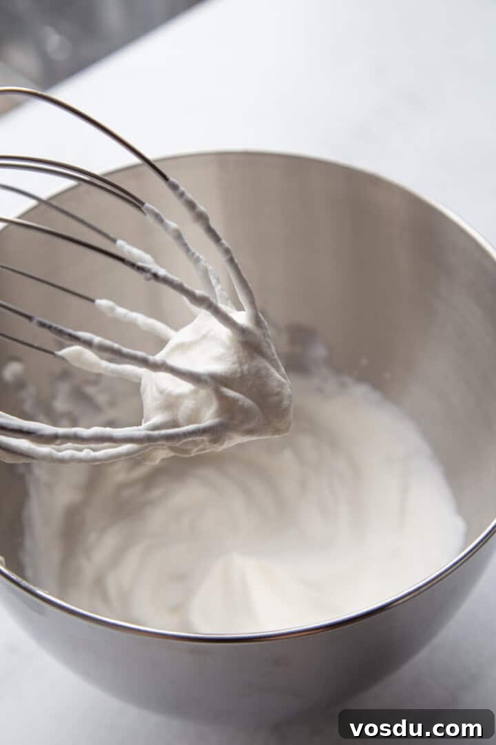 Cherry Delight: Homemade Cherry Dessert Recipes for Summer 7 whipped cream in a metal bowl with a beater.