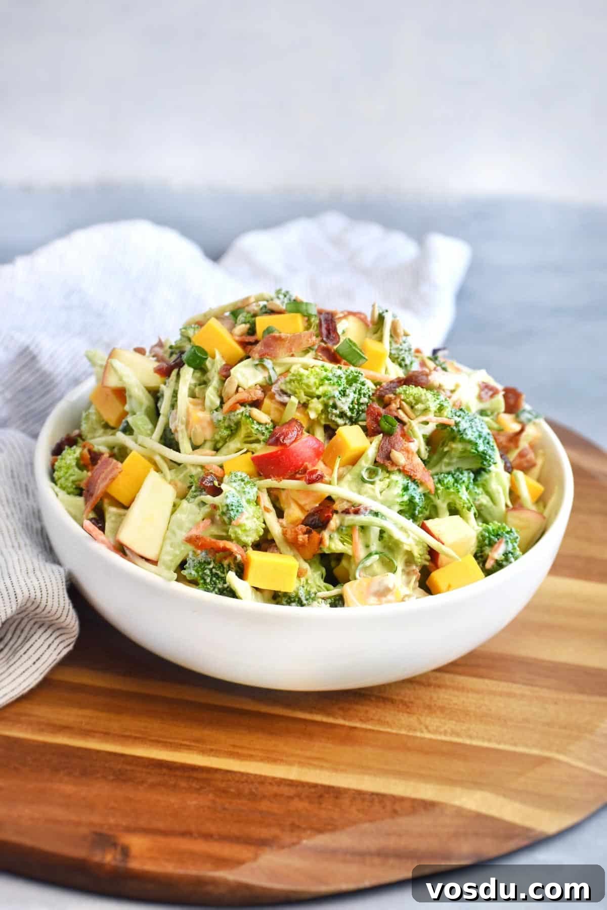 Broccoli Salad with Greek Yogurt Dressing – Light and Creamy 2 bowl of broccoli salad on wooden board.