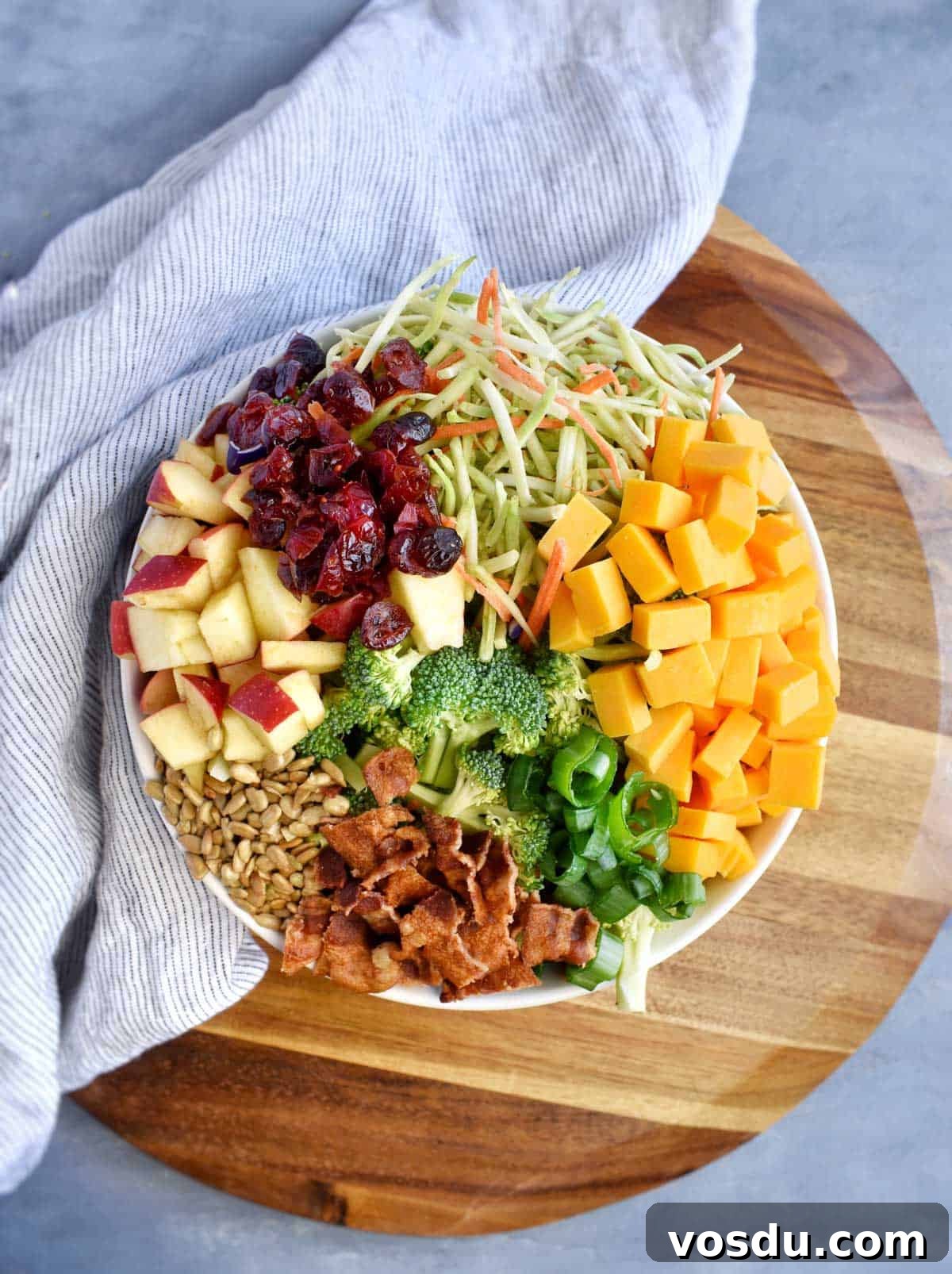 Broccoli Salad with Greek Yogurt Dressing – Light and Creamy 5 broccoli salad ingredients in white serving bowl.