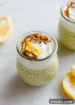 A cup of lemon chia pudding topped with yogurt, graham cracker crumbs, and a lemon twist.